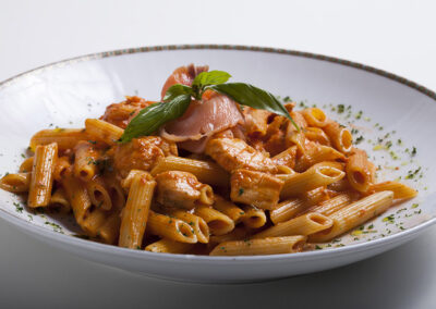 rigatoni pasta with a basil leaf on top